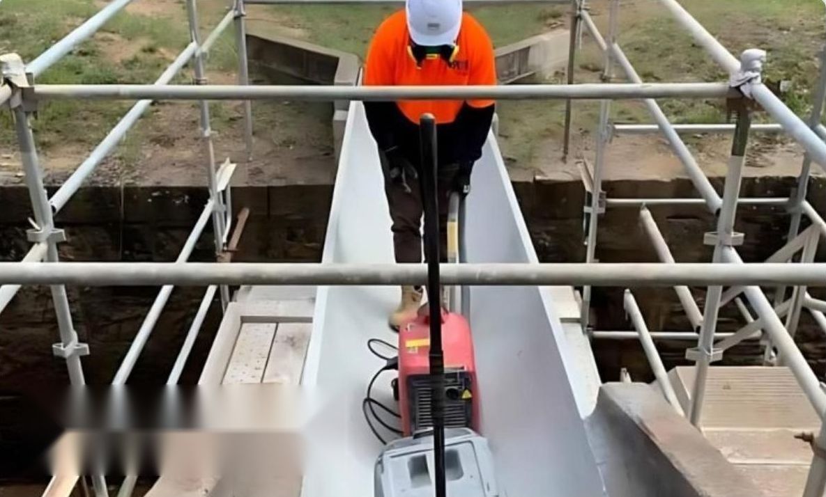 Worker in a water channel on the NSW Water Project